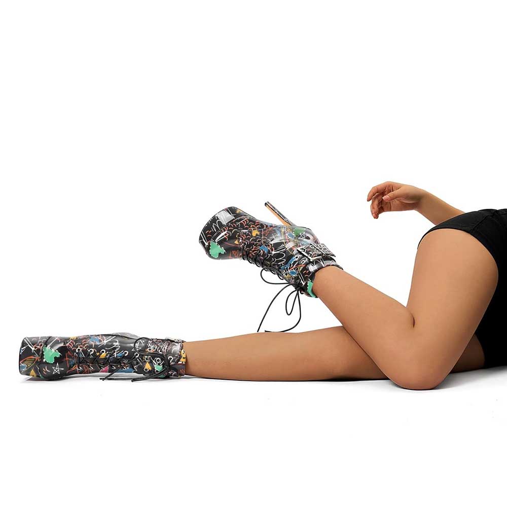 Black multi-color platform pumps ankle boots with graffiti design worn on legs