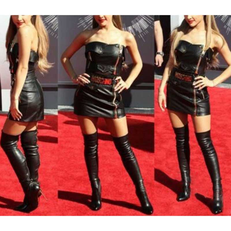 Black pointed toe over-the-knee boots worn with a black mini leather dress on a red carpet