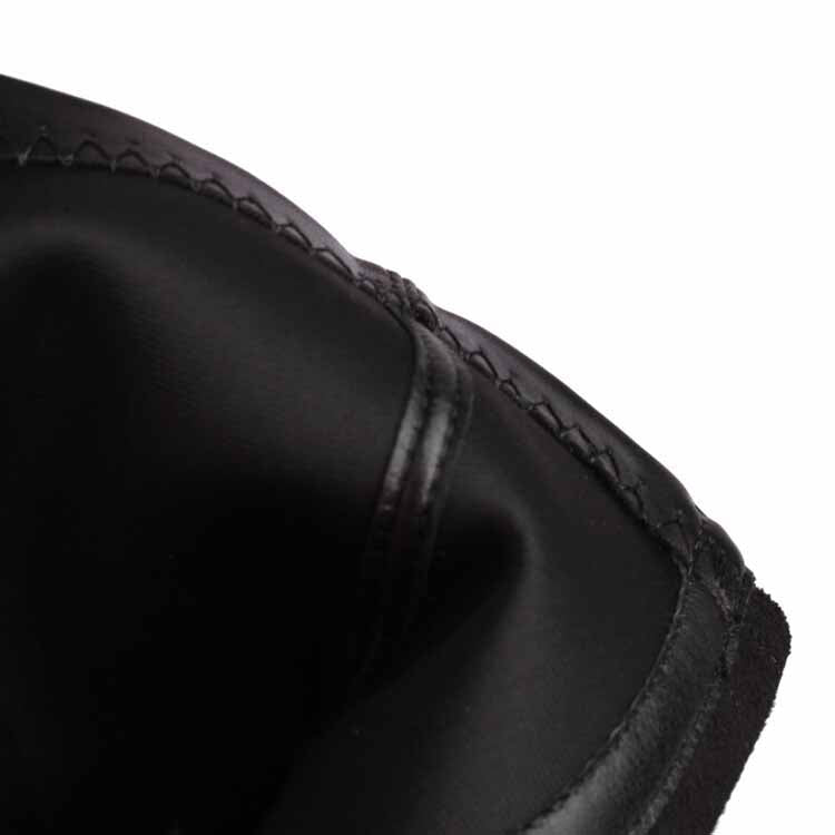 Close-up view of black chunky heeled boots for women showing smooth leather and stitching details