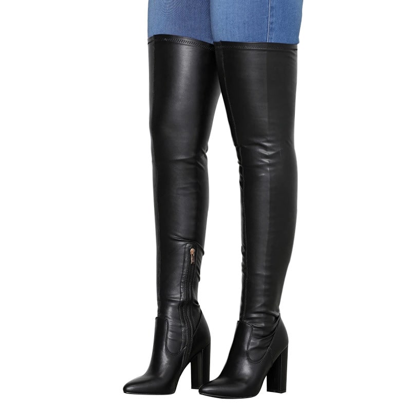 Black leather chunky heeled over the knee boots worn with blue skinny jeans