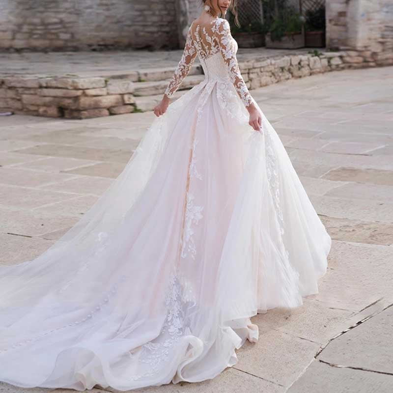 Elegant lace wedding dress with sleeves featuring intricate lace back design and long flowing train