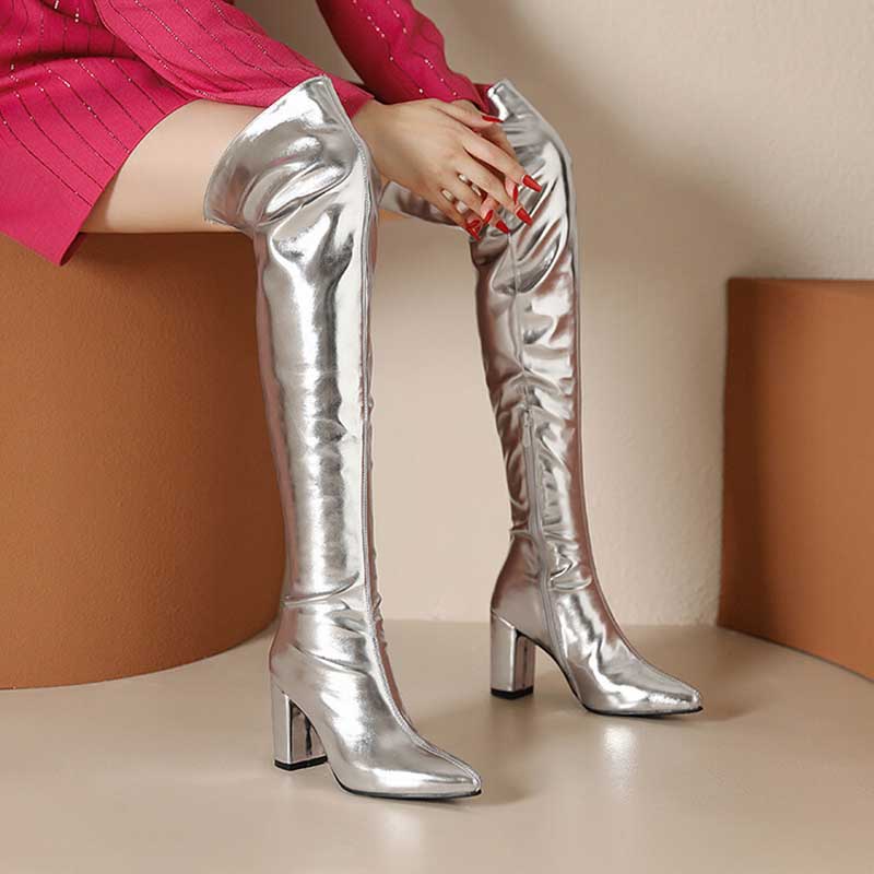 Metallic over the knee boots women in shiny silver with block heels styled with a red dress
