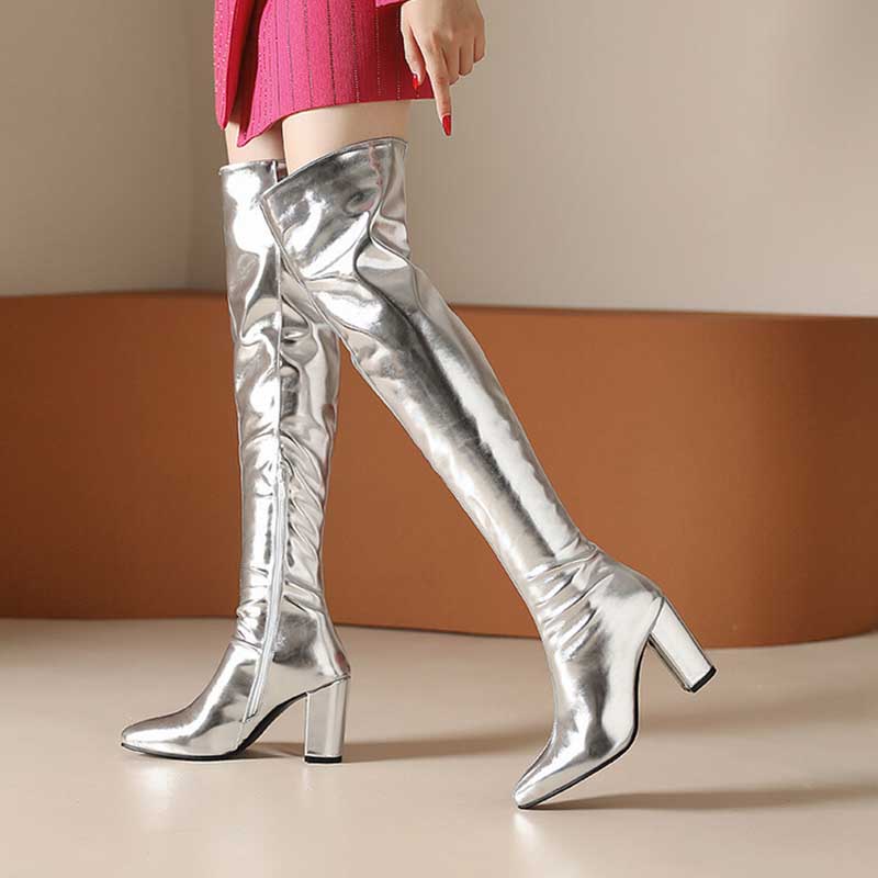 Metallic over the knee boots women with block heels and shiny silver finish paired with a pink skirt