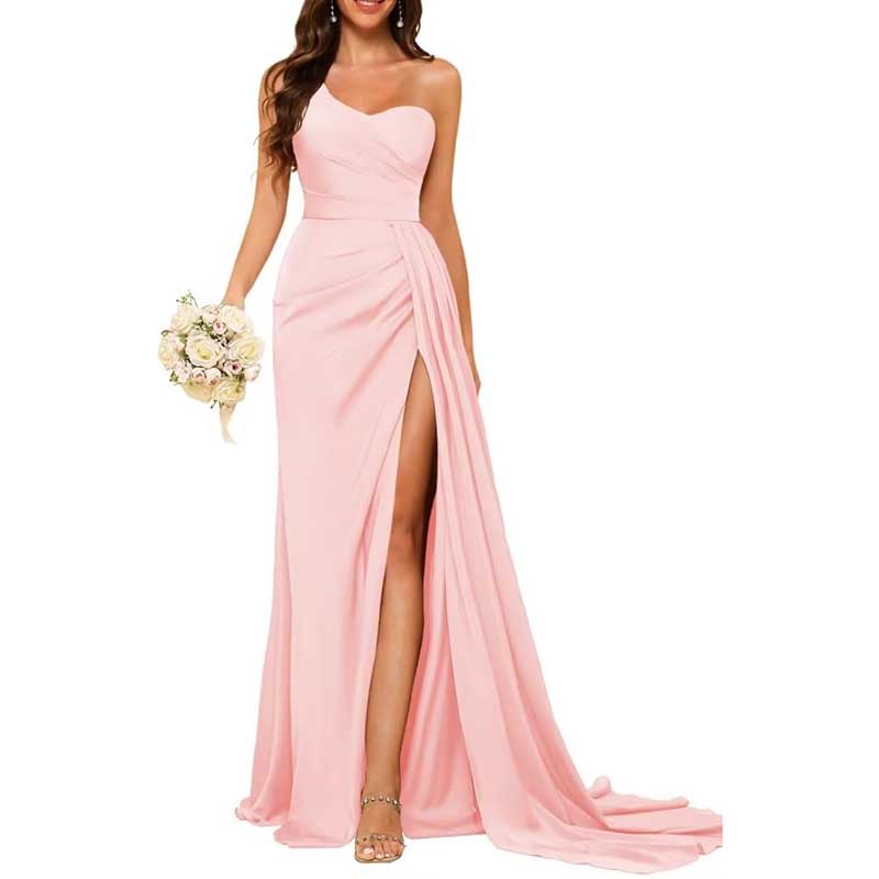 Elegant pink one shoulder bridesmaid dress with side slit and flowing train holding bouquet