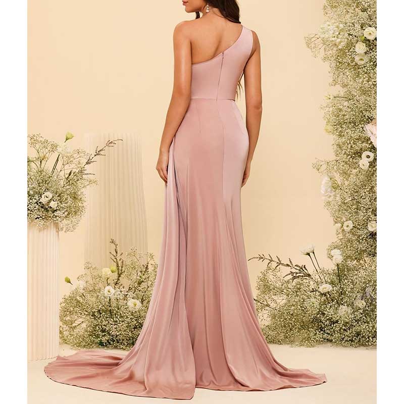 Elegant pink one shoulder bridesmaid dress with flowing train and fitted waist detail