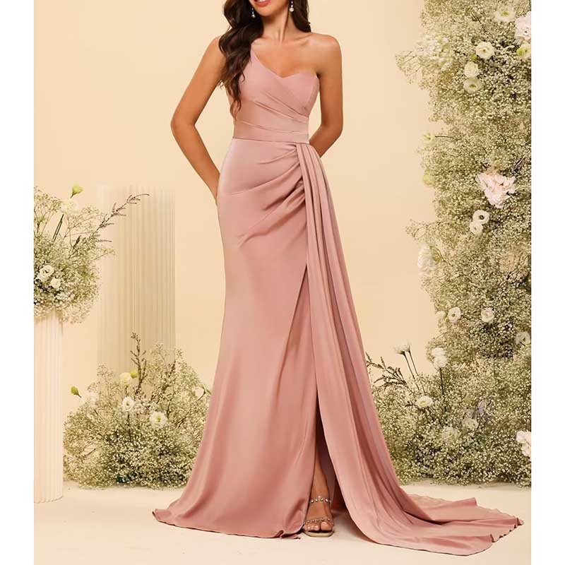Elegant blush pink one shoulder bridesmaid dress with draped detail and floor-length skirt