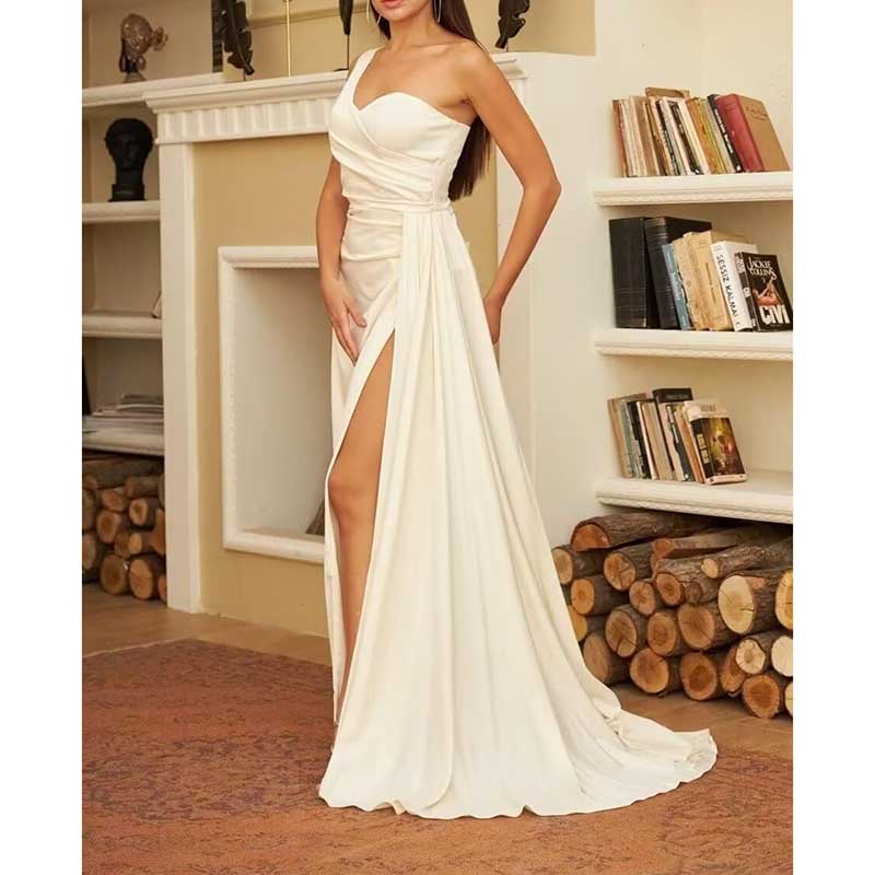 Elegant white one shoulder bridesmaid dress with a thigh-high slit and flowing skirt