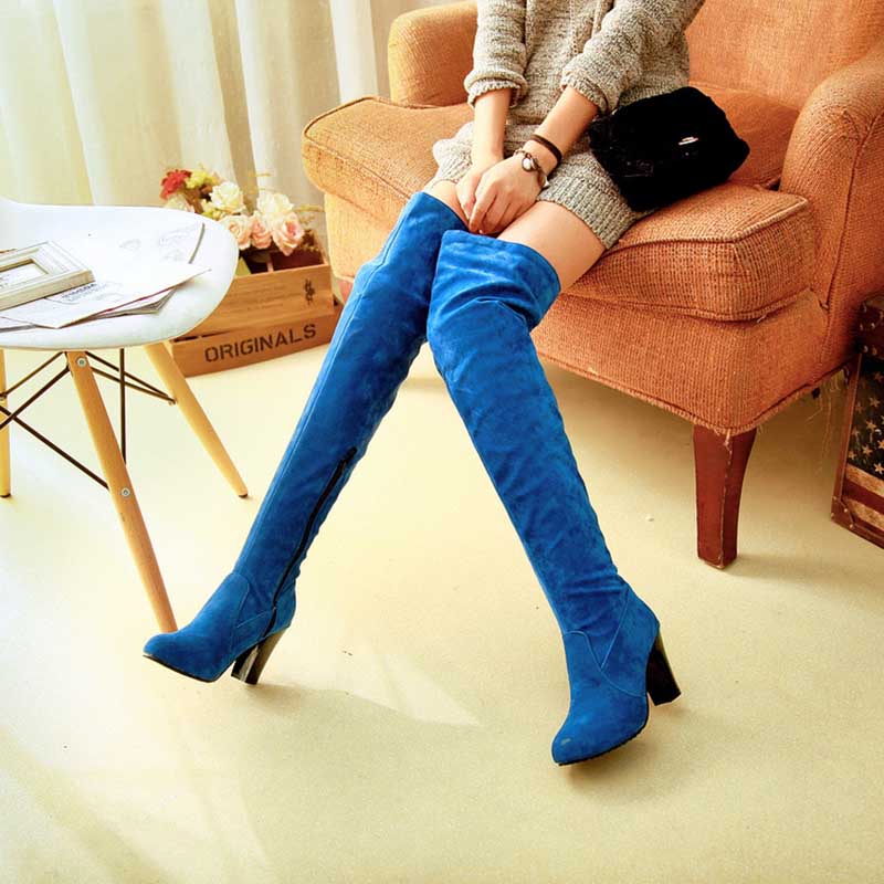 Blue suede plus size thigh high boots for women with block heels worn by seated model