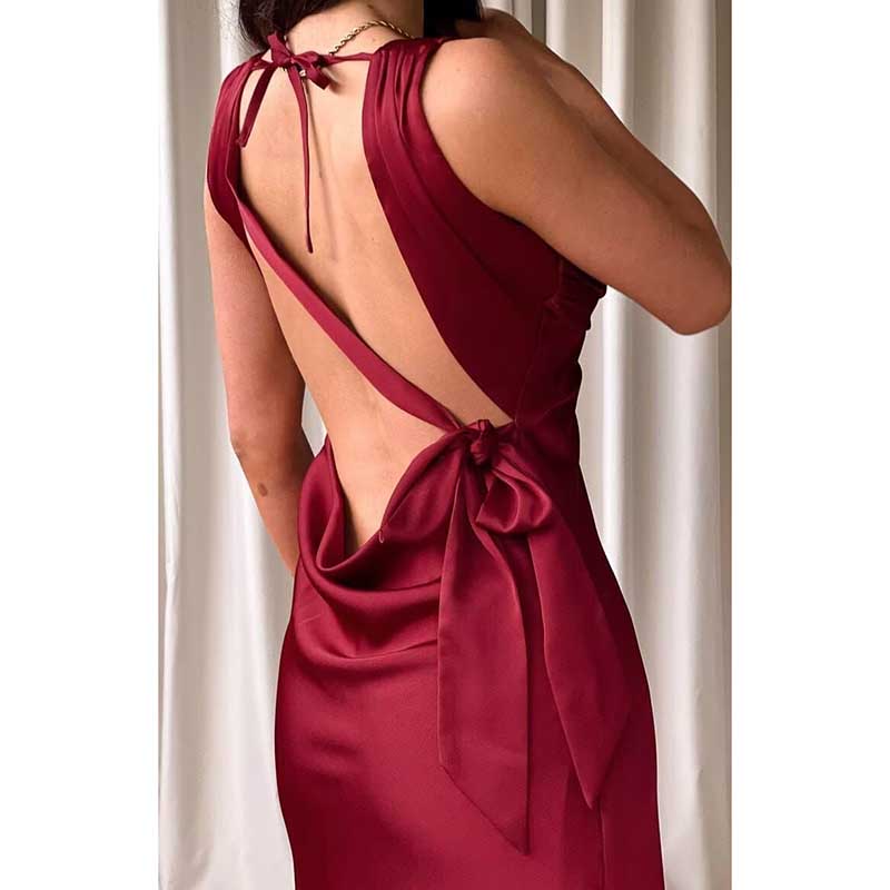 Back view of a red satin spaghetti strap bridesmaid gown with open back and bow detail