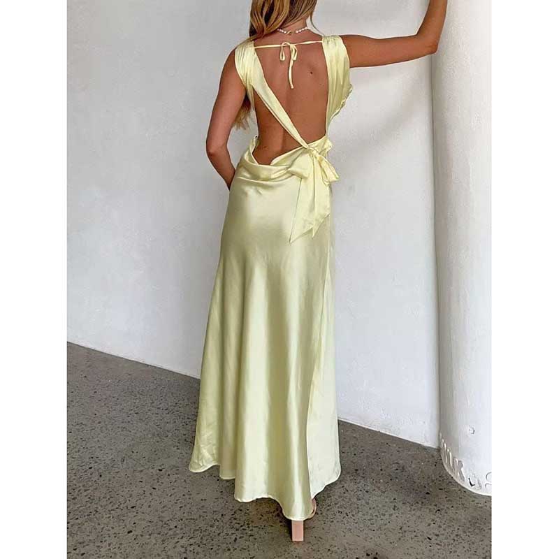 Back view of yellow satin spaghetti strap bridesmaid gown with open back and bow tie detail