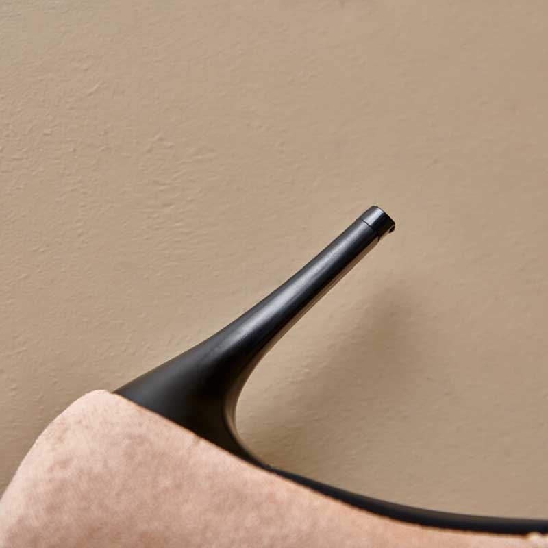 Close-up of beige suede knee high boots for special occasions with slim black stiletto heel