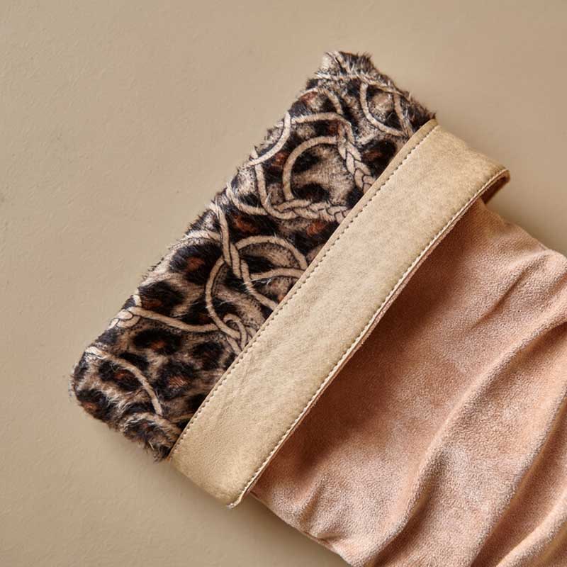 Close-up of suede knee high boots for special occasions with leopard print and beige trim
