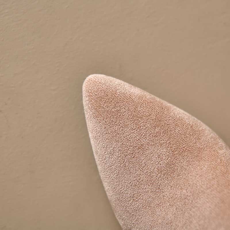 Close-up of pointed toe on beige suede knee high boots for special occasions