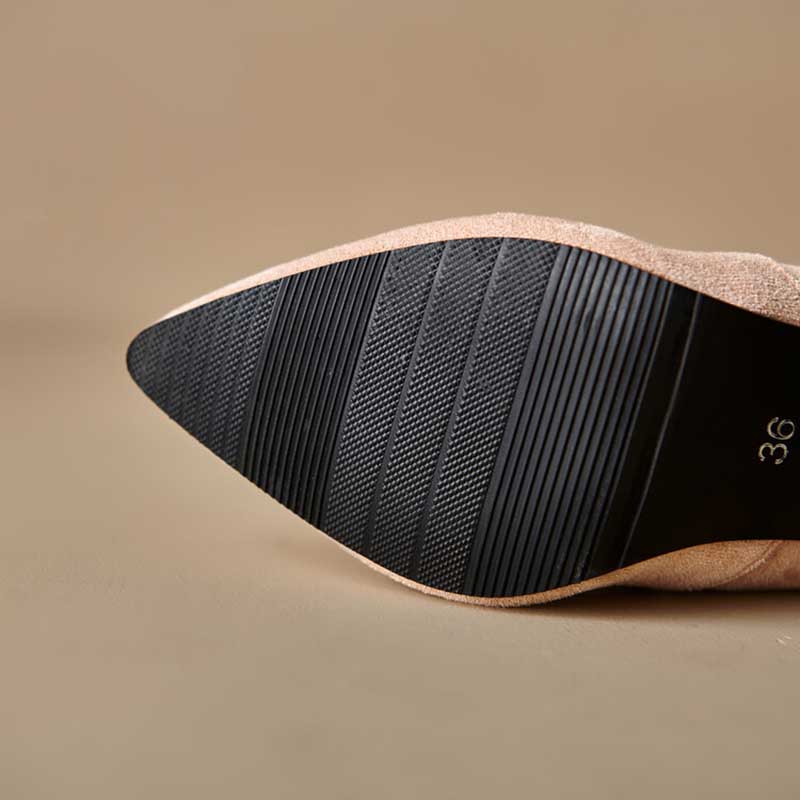 Close-up of the sole of suede knee high boots for special occasions in beige color