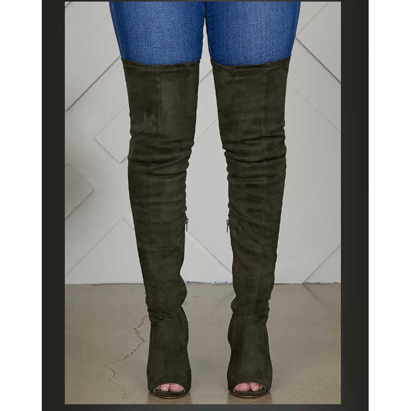 Black suede high heeled over the knee boots for women worn with blue jeans