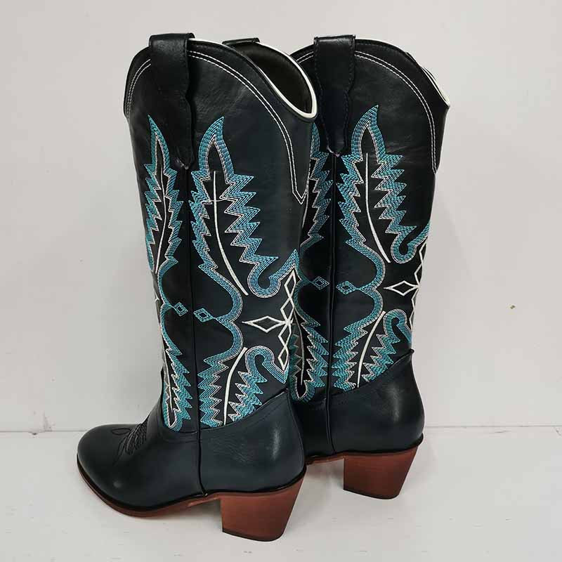 Vintage knee high cowboy boots in black leather with blue and white decorative stitching