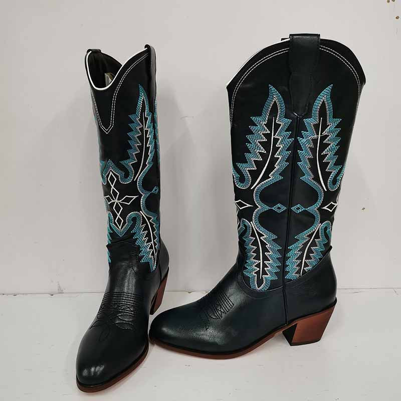 Vintage knee high cowboy boots in black leather with blue and white stitched design