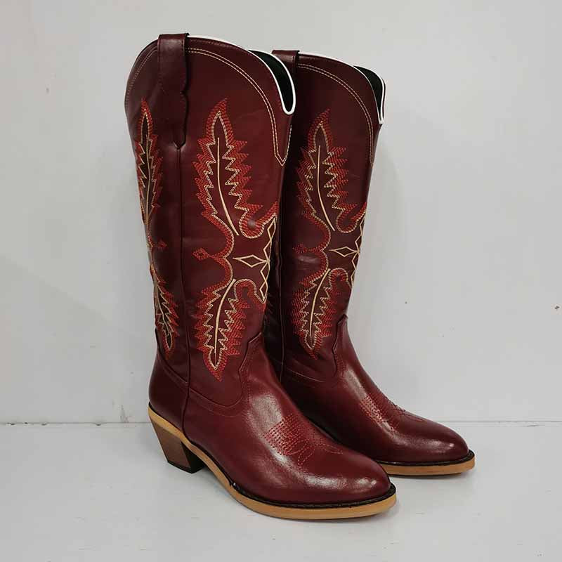 Vintage knee high cowboy boots in rich brown leather with decorative stitching and stacked heel