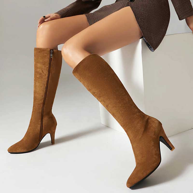 Brown women's suede knee-high boots with side zipper and pointed toe on model sitting