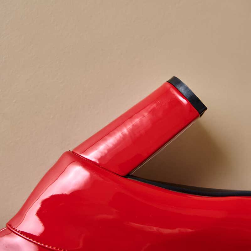 Red glossy women's chunky heel boots for prom with black trim detailing on heel and edge