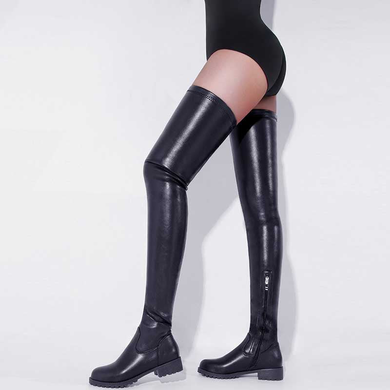 Black leather womens thigh high boots with low heel and side zipper on model's legs