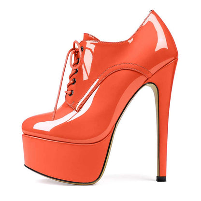 Orange high heel platform ankle boots with lace-up front and glossy finish