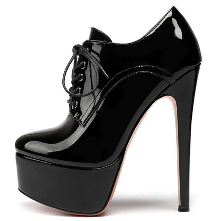 Black round toe booties for women with high stiletto heel and platform sole in shiny patent finish