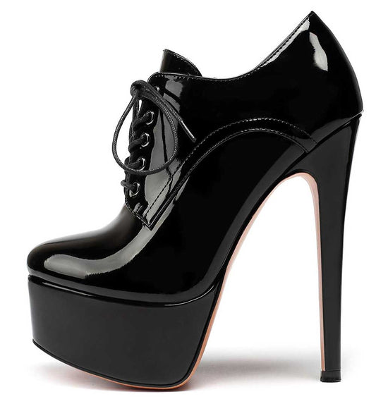 Black round toe booties for women with high stiletto heel and platform sole in shiny patent finish
