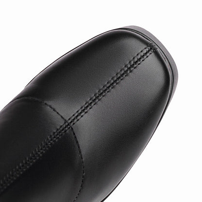 Close up of black leather chunky heeled boots for women with detailed stitching on toe