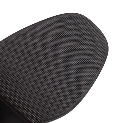 Close-up of black sole texture on chunky heeled boots for women showing detailed grip pattern