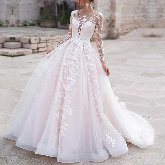 Elegant lace wedding dress with sleeves featuring intricate floral embroidery and a flowing tulle skirt