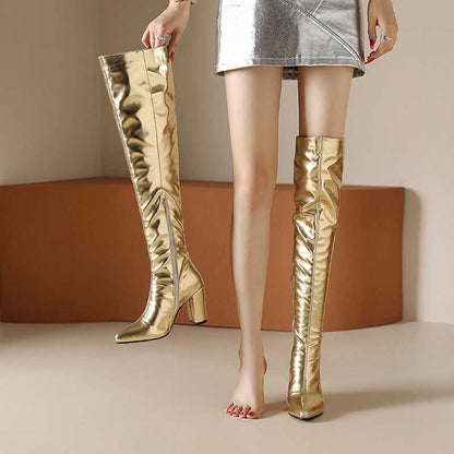 Metallic over the knee boots women in shiny gold with block heels styled with a silver mini skirt