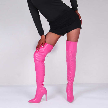 Bright pink over the knee boots for women with high heels styled with a black mini dress