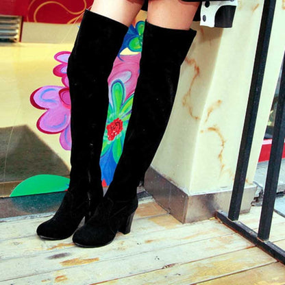 Black plus size thigh high boots for women with block heels worn indoors