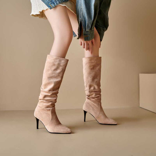 Light tan suede knee high boots for special occasions with mid-height heels worn with skirt and jacket