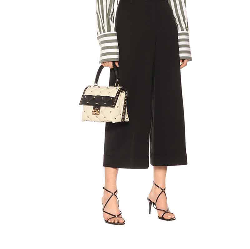 Black strappy open toe summer dress heels worn with cropped black pants and striped blouse