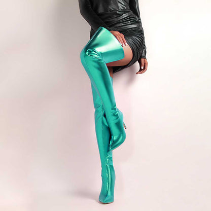 Shiny leather high heel over the knee boots for women in metallic teal worn with black dress
