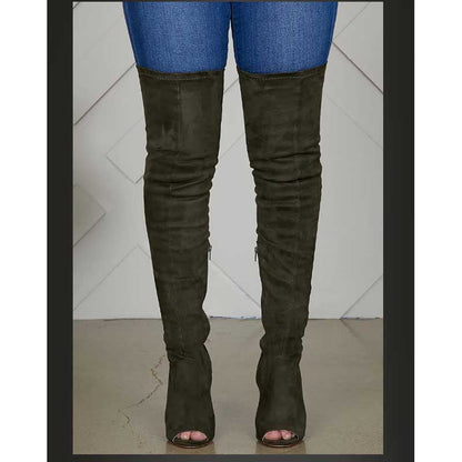 Black suede high heeled over the knee boots for women worn with blue jeans