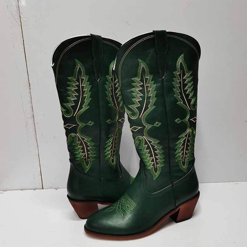 Vintage knee high cowboy boots in dark green leather with detailed green stitching and brown heels