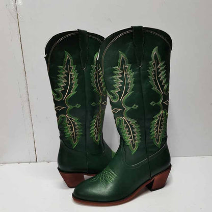 Vintage knee high cowboy boots in dark green leather with detailed green stitching and brown heels