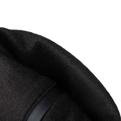 Close-up of black women's suede knee-high boots showing soft textured material and strap detail