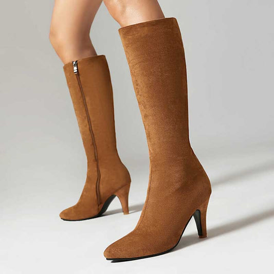 Brown women's suede knee-high boots with pointed toe and mid heel on light background