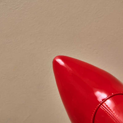 Close-up of red women's chunky heel boots for prom with glossy finish and pointed toe