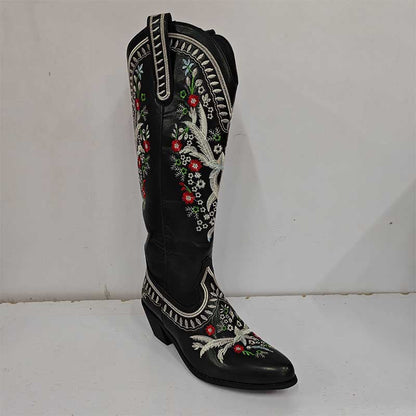 Black women's embroidered cowboy boots featuring colorful floral stitching and decorative trim