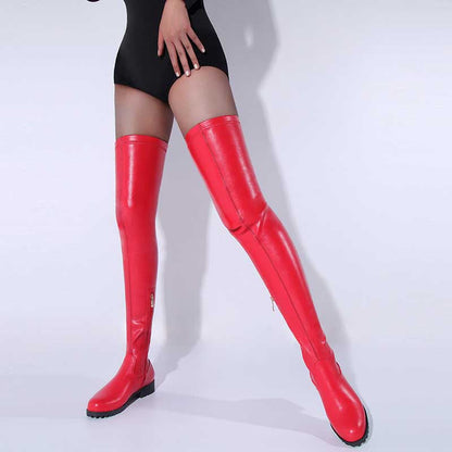 Red womens thigh high boots with flat sole worn with black bodysuit against white background